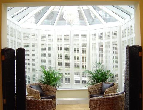 Transitional Sunroom with natural fiber chair