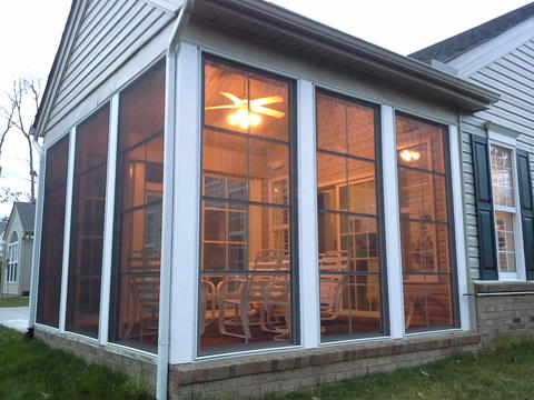 Traditional Sunroom with brick home exterior