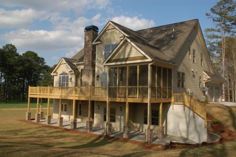Traditional Home Exterior with light wood support columns