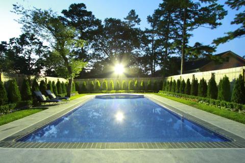 Traditional Pool with tall cement brick privacy walls