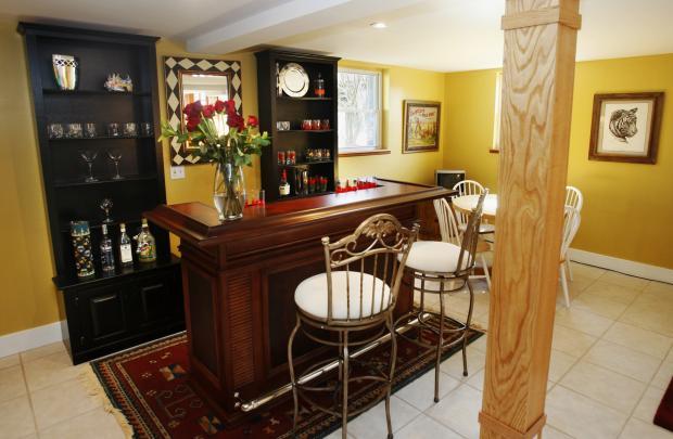 Eclectic Bar with metal bar chairs with white cushions
