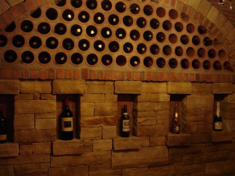 Traditional Wine Cellar with below round holes a row of boxed space for wine stand