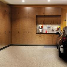 Contemporary Garage with medium wood stained cabinets