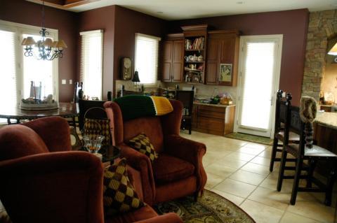Traditional Family Room with red upholstered wing back chairs