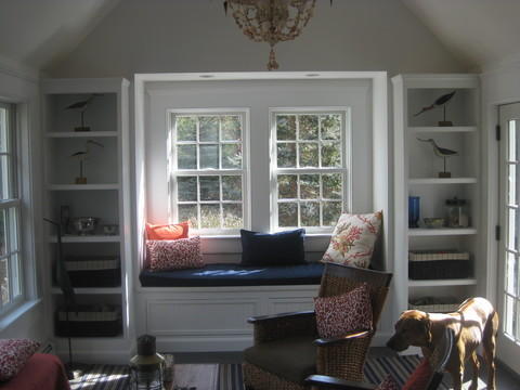 Transitional Sunroom with white built in book case