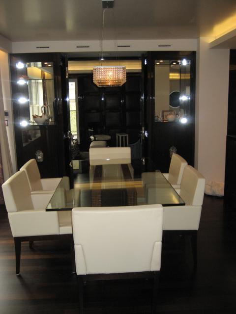 Modern Dining Room with large black built-in china cabinets