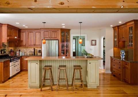 Eclectic Kitchen with raised panel medium stained cabinets
