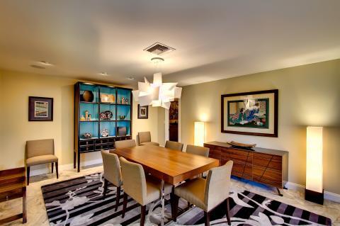 Eclectic Dining Room with tall china cabinet with bright blue backsplash