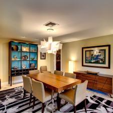 Eclectic Dining Room with tall china cabinet with bright blue backsplash
