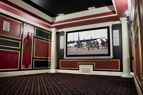 Traditional Home Theater with black and gold carpeted flooring