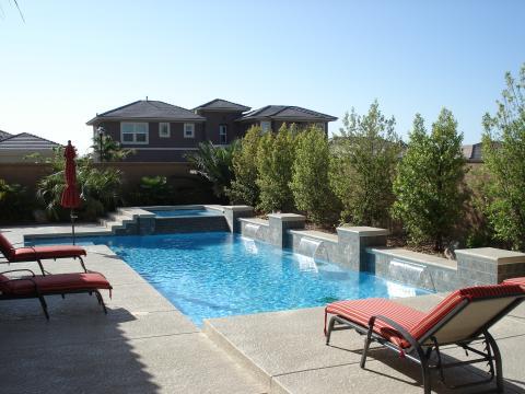 Traditional Pool with black metal lounge chairs