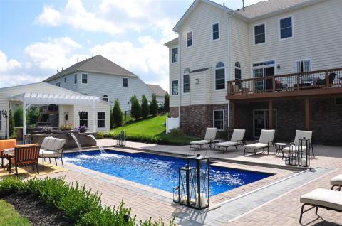 Traditional Pool with hidden automatic pool safety cover