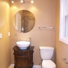 Traditional Powder Room with dark wood elegant vanity cabinet