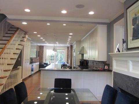 Transitional Dining Room with gray marble fire place facing
