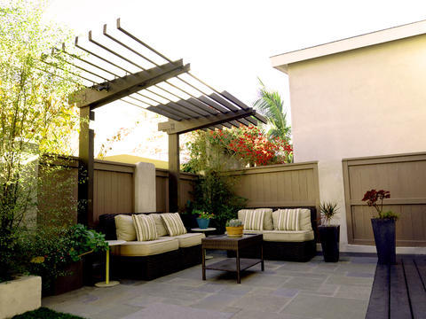 Contemporary Patio with brown composite fence