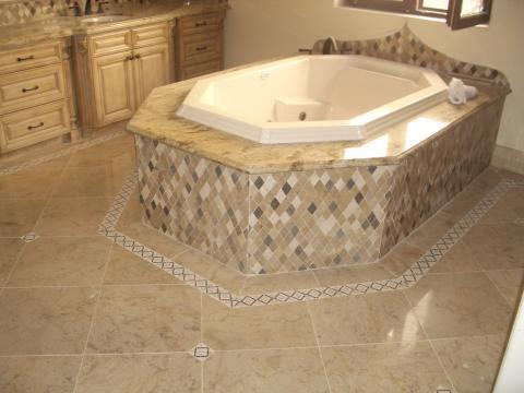 Traditional Master Bathroom with granite tub surround