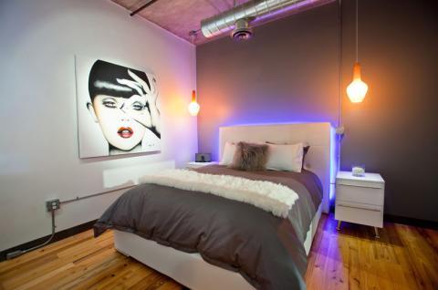 Contemporary Bedroom with pendant lights above end table