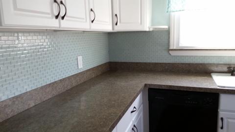 Cape Cod Kitchen with brown solid surface synthetic countertop