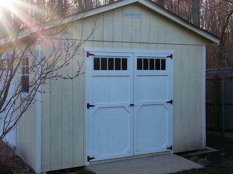 Colonial Garage with black metal hinges