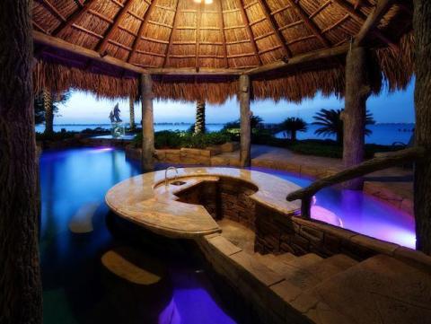 Traditional Pool with rustic log columns around pool