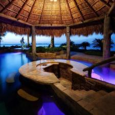 Traditional Pool with rustic log columns around pool