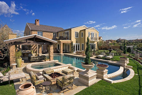 Traditional Pool with white stone surrounding pool