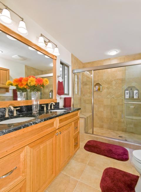 Traditional Master Bathroom with light wood stained vanity cabinet
