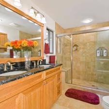 Traditional Master Bathroom with light wood stained vanity cabinet