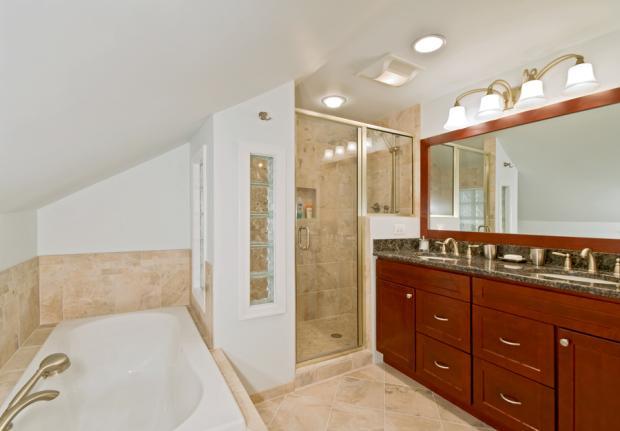Traditional Master Bathroom with tan tile shower wall covering