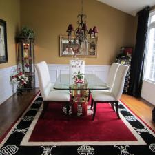 Eclectic Dining Room with red and black area rug