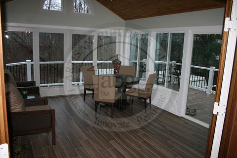 Transitional Sunroom with wide plank hardwood flooring