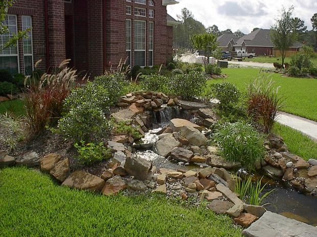 Traditional Landscape with grass landscaped yard