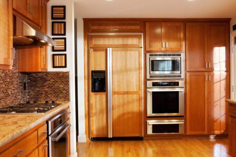 Modern Kitchen with side by side refrigerator with cabinet door paneling