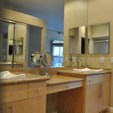 Contemporary Master Bathroom with light wood vanity cabinets