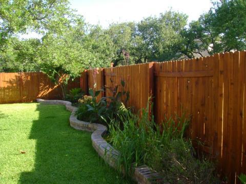 Traditional Landscape with medium wood privacy fence