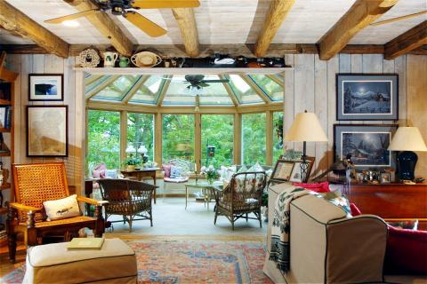 Traditional Family Room with displayed antiques on shelves above doorway