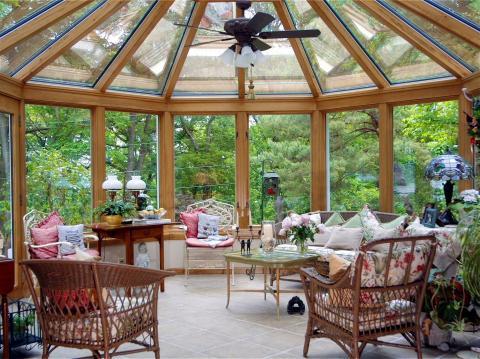 Eclectic Sunroom with light wood stained millwork