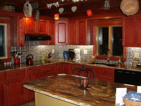 Eclectic Kitchen with textured aluminum back splash