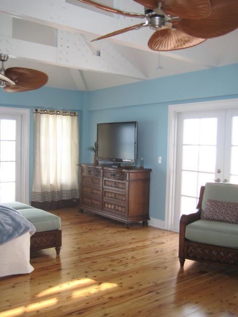 Tropical Bedroom with palm leaf ceiling fan