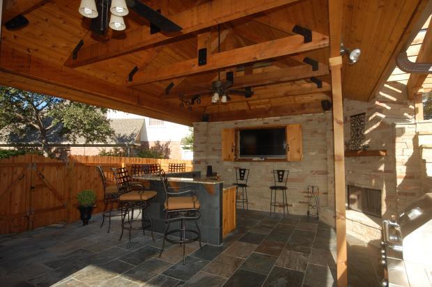 Traditional Outdoor Kitchen with hanging ceiling fans and lights