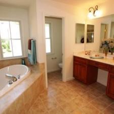 Transitional Master Bathroom with dark wood vanity cabinet