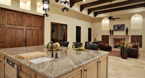 Traditional Family Room with cream kitchen island cabinet and medium stained cabinets