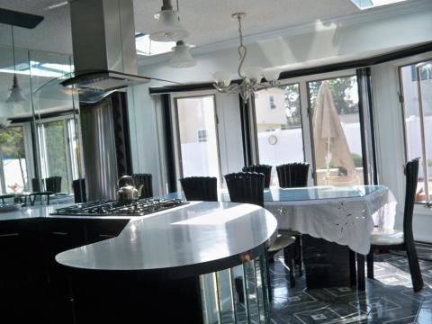 Contemporary Dining Room with stainless steel stove hood