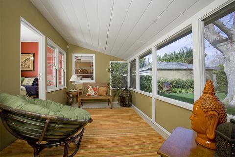 Eclectic Sunroom with striped colorful area rug