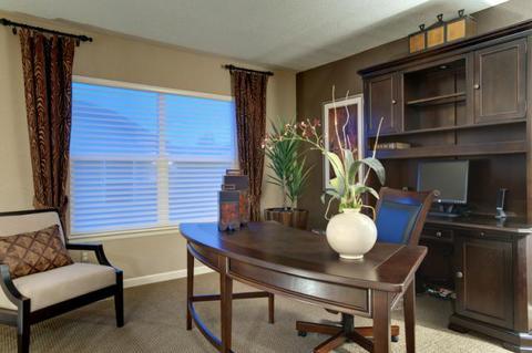 Traditional Home Office with dark wood executive chair on wheels