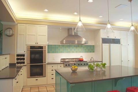 Eclectic Kitchen with white panel covered fridge