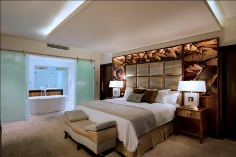 Contemporary Bedroom with unique design of wall with picture of rocks