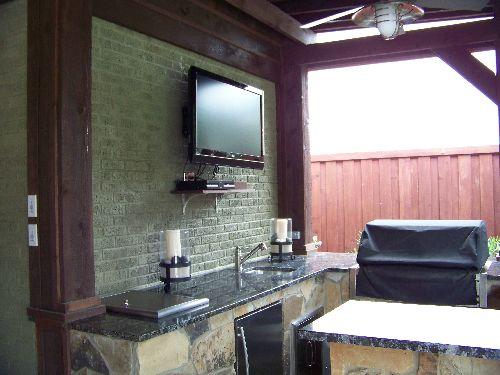 Traditional Outdoor Kitchen with wall mounted flat screen tv