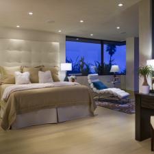 Transitional Bedroom with large white upholstered head board