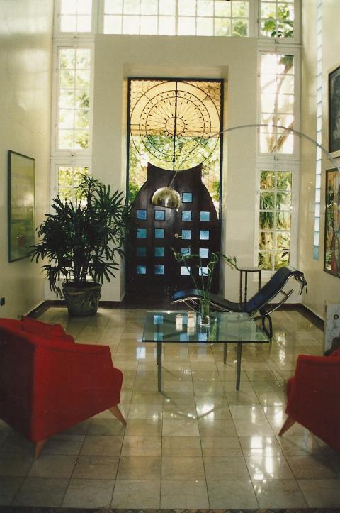 Contemporary Sunroom with black leather lounge chairs